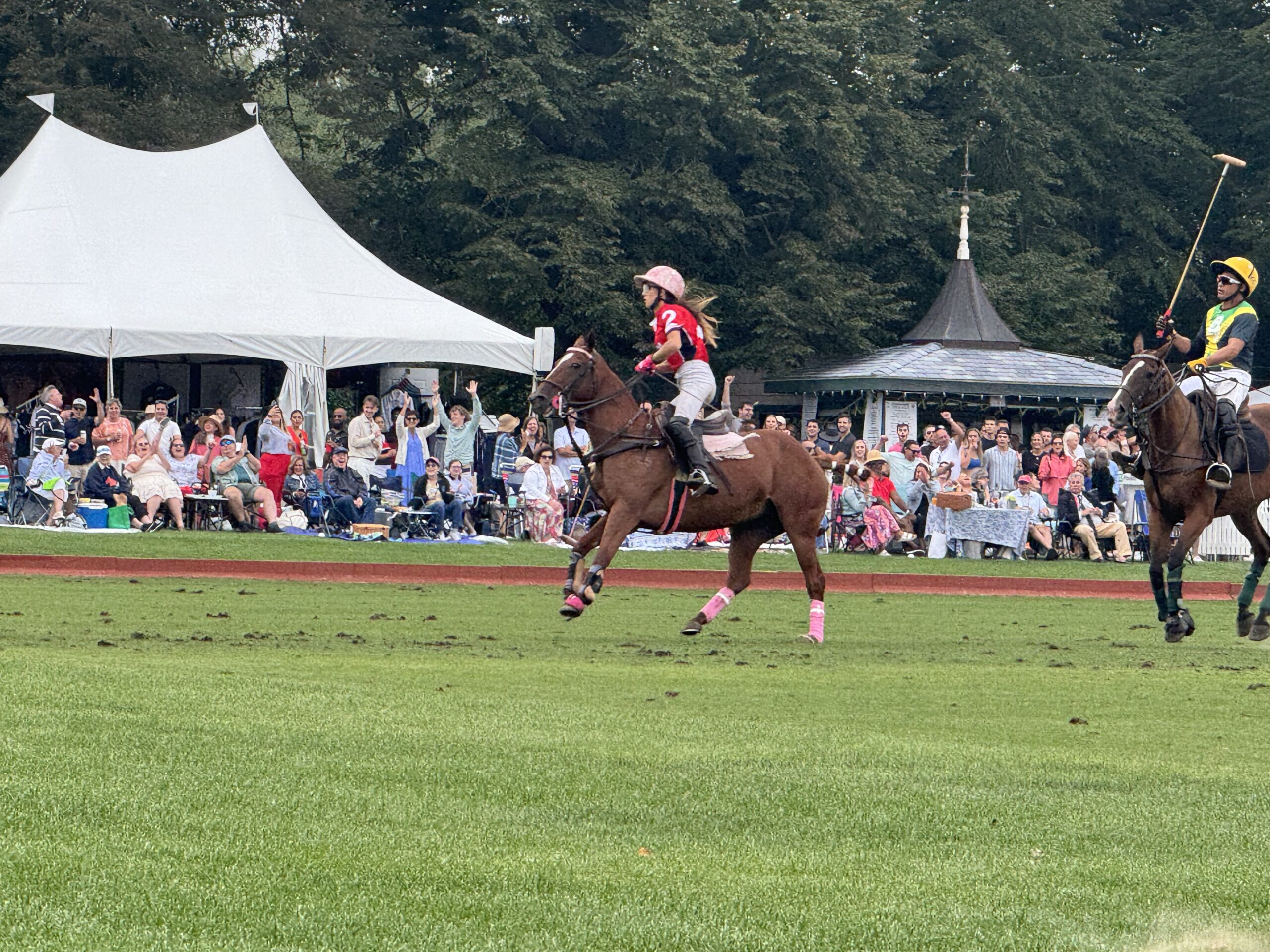 Polo players competing on horseback during a Newport International Polo Series match at Glen Farm